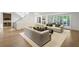 Bright living room with hardwood floors, neutral couches, fireplace and a view of the back yard at 5260 Long Island Nw Dr, Atlanta, GA 30327