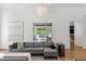 Bright living room features a comfortable gray sofa and view to the outdoor living area at 5260 Long Island Nw Dr, Atlanta, GA 30327