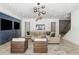 Modern living room featuring stylish lighting, a comfortable beige sectional, and large-screen TVs at 5260 Long Island Nw Dr, Atlanta, GA 30327