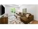 Comfortable living room with a large sectional sofa, stylish rug, and natural light from the window at 5260 Long Island Nw Dr, Atlanta, GA 30327