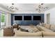Spacious living room with modern lighting, comfortable seating, and a wall-mounted entertainment system at 5260 Long Island Nw Dr, Atlanta, GA 30327