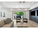 Bright living room with sliding glass doors, neutral furniture, and a sleek entertainment center at 5260 Long Island Nw Dr, Atlanta, GA 30327