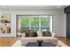 Living room with hardwood floors and a view of the backyard through floor to ceiling sliding glass doors at 5260 Long Island Nw Dr, Atlanta, GA 30327