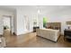 Spacious main bedroom with hardwood floors, neutral decor and connecting doors to other rooms at 5260 Long Island Nw Dr, Atlanta, GA 30327