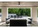 Covered patio with ample seating, overlooking a pool and lush green landscape at 5260 Long Island Nw Dr, Atlanta, GA 30327