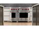 Close up view of the professional, stainless steel Wolf oven with red knobs at 5260 Long Island Nw Dr, Atlanta, GA 30327