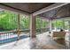 Screened in outdoor patio featuring views of the pool and backyard, wood ceiling, and tiled floors at 5260 Long Island Nw Dr, Atlanta, GA 30327