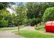 Beautiful playground surrounded by lush greenery, featuring climbing structures and slides for active outdoor play at 5260 Long Island Nw Dr, Atlanta, GA 30327
