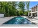 Backyard swimming pool with surrounding lounge area and lush greenery at 5260 Long Island Nw Dr, Atlanta, GA 30327