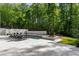 An inviting outdoor pool and hot tub is surrounded by ample seating and lush greenery at 5260 Long Island Nw Dr, Atlanta, GA 30327
