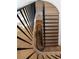 Aerial view of a curved staircase featuring hardwood steps and black metal railings at 5260 Long Island Nw Dr, Atlanta, GA 30327
