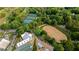 Aerial shot of the community tennis courts, riding arena, and other amenities, surrounded by lush green trees at 5260 Long Island Nw Dr, Atlanta, GA 30327