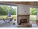 Covered back porch with stone fireplace and view of backyard at 613 Nebo Rd, Dallas, GA 30157