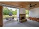 Covered back porch with stone fireplace and view of backyard at 613 Nebo Rd, Dallas, GA 30157