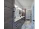 Bathroom with dual sinks, white counters, and gray cabinets with black hardware at 613 Nebo Rd, Dallas, GA 30157