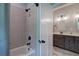 Bathroom featuring a bathtub with shower, and double vanity with gray cabinets and a white countertop at 613 Nebo Rd, Dallas, GA 30157