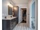Bathroom with double sink vanity and walk-in closet/dressing area at 613 Nebo Rd, Dallas, GA 30157