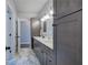 Bathroom featuring a double vanity with gray cabinets, white countertop, and modern lighting at 613 Nebo Rd, Dallas, GA 30157