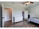 Bedroom with wood-look floors, a white dresser, and a ceiling fan with lights at 613 Nebo Rd, Dallas, GA 30157