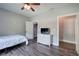 Bedroom with wood-look floors, a white dresser, and a ceiling fan with lights at 613 Nebo Rd, Dallas, GA 30157