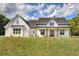 Charming two-story farmhouse featuring white siding, a cozy porch swing, and a well-manicured front lawn at 613 Nebo Rd, Dallas, GA 30157