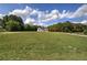 Secluded two-story farmhouse sits majestically on a large, grassy lot with a tree-lined backdrop, offering privacy at 613 Nebo Rd, Dallas, GA 30157