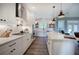 Modern kitchen featuring stainless appliances, white cabinets and connecting living area at 613 Nebo Rd, Dallas, GA 30157