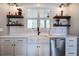 Charming kitchen sink area with custom shelving and modern fixtures at 613 Nebo Rd, Dallas, GA 30157