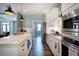 Well-lit kitchen with stainless steel appliances, white cabinets, and a center island at 613 Nebo Rd, Dallas, GA 30157
