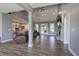 Open-concept living area with high ceilings, wood floors, stone fireplace, and kitchen access with views to the outside at 613 Nebo Rd, Dallas, GA 30157
