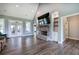 Bright living room with French doors, stone fireplace, built-in shelves, and modern design, offering a comfortable living space at 613 Nebo Rd, Dallas, GA 30157