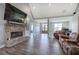Cozy living room with wood floors, stone fireplace, comfortable seating, and natural light, designed for relaxation and comfort at 613 Nebo Rd, Dallas, GA 30157