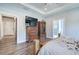Spacious bedroom featuring tray ceiling, wood furniture, ensuite bath, and wood-look flooring at 613 Nebo Rd, Dallas, GA 30157