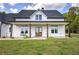 Inviting front porch with wood columns, a porch swing, and double front doors, perfect for relaxing outdoors at 613 Nebo Rd, Dallas, GA 30157