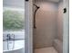 Modern tiled shower with a built-in bench and a view of the soaking tub at 613 Nebo Rd, Dallas, GA 30157