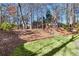 Expansive backyard featuring a playset, grassy area, and stone steps leading to an upper level at 893 Brookgreen Pl, Lawrenceville, GA 30043