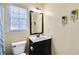 Cozy bathroom with a modern vanity, black fixtures, and a window that provides natural light at 893 Brookgreen Pl, Lawrenceville, GA 30043
