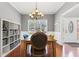 Elegant dining room with hardwood floors, chandelier, and bright window at 893 Brookgreen Pl, Lawrenceville, GA 30043