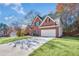 A brick two-story home features a well-maintained lawn, two-car garage, and mature trees at 893 Brookgreen Pl, Lawrenceville, GA 30043