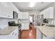 Modern kitchen with white cabinets, granite countertops, and stainless steel appliances at 893 Brookgreen Pl, Lawrenceville, GA 30043
