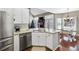 Bright eat-in kitchen with stainless steel appliances, granite countertops, and a view to the Gathering room at 893 Brookgreen Pl, Lawrenceville, GA 30043