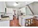 Modern kitchen with white cabinets, granite countertops, and stainless steel appliances at 893 Brookgreen Pl, Lawrenceville, GA 30043