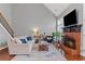 Inviting living room with a brick fireplace, hardwood floors, and high ceiling at 893 Brookgreen Pl, Lawrenceville, GA 30043