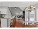 Open-concept kitchen and living room with granite countertops and staircase view at 893 Brookgreen Pl, Lawrenceville, GA 30043