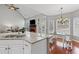 Open-concept kitchen and living room with granite countertops and natural light at 893 Brookgreen Pl, Lawrenceville, GA 30043