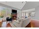 Bright living room with fireplace, hardwood floors, and open concept design to dining area at 893 Brookgreen Pl, Lawrenceville, GA 30043