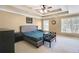 Spacious main bedroom boasts a tray ceiling, ceiling fan, and windows that provide natural light at 893 Brookgreen Pl, Lawrenceville, GA 30043