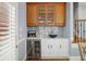 Convenient bar area with wine fridge, marbled backsplash, and glass door cabinets at 225 Farmbrooke Ct, Sandy Springs, GA 30350