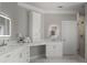 Bright bathroom featuring dual sinks, modern mirrors, and a walk-in shower with marble tiling at 225 Farmbrooke Ct, Sandy Springs, GA 30350