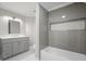 Bathroom boasts a tub-shower with gray subway tile, herringbone niche and gray vanity at 225 Farmbrooke Ct, Sandy Springs, GA 30350